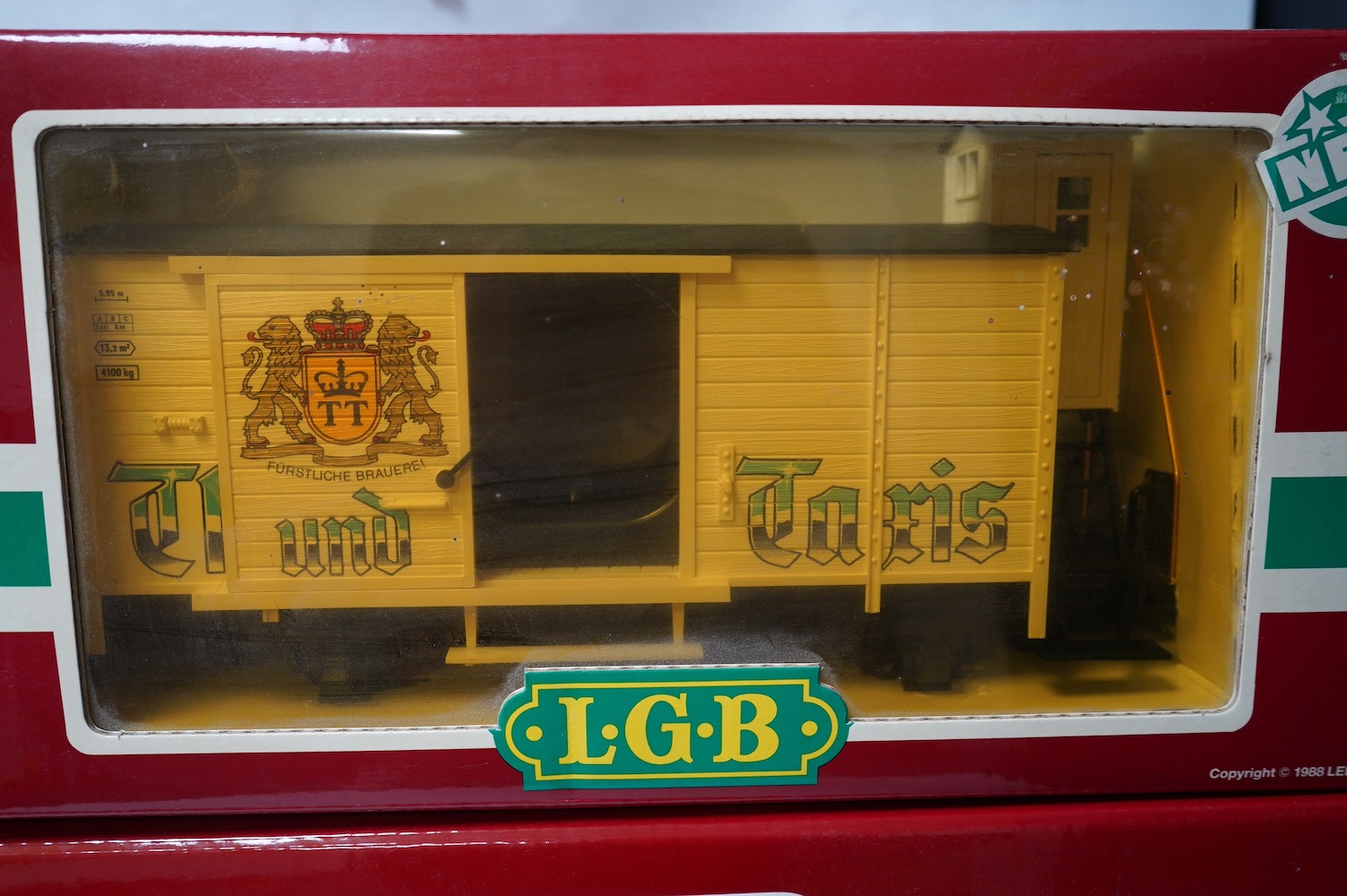 Three boxed Lehmann LGB G scale rolling stock; a bogie well wagon with transformer load (4058), A bogie beer box van (40570), and a 4-wheel box van (4126). Condition - good.